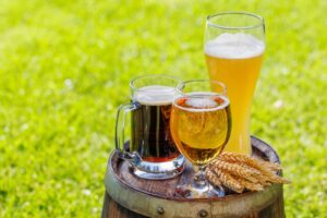 variety of beer glasses on rustic wooden barrel 2024 02 04 02 31 48 utc