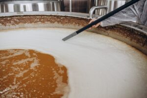 brewer man in apron standing among beer vats 2023 11 27 04 57 15 utc